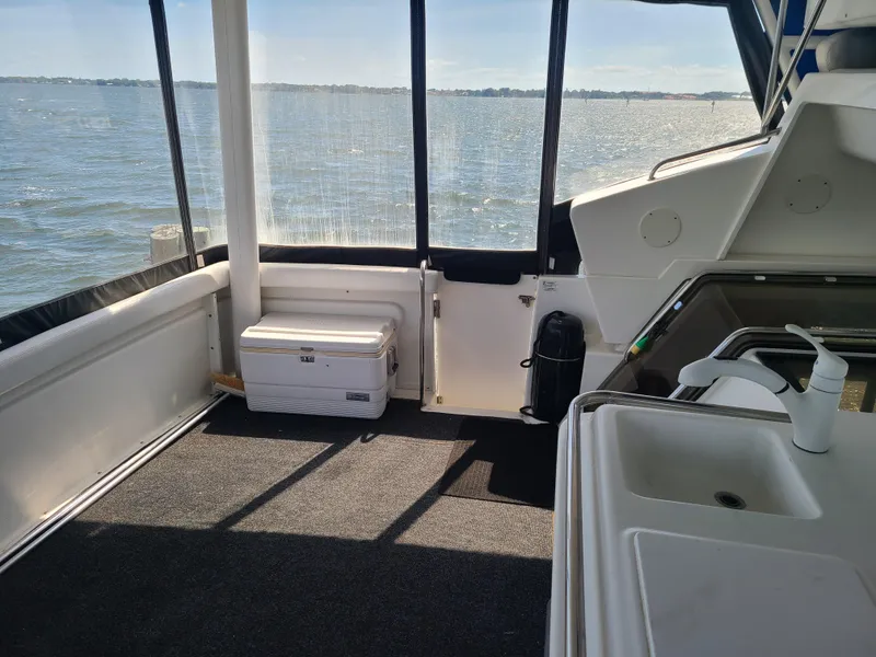 Slide: The Image of 1997 Silverton 372 Motor Yacht interior with sink, cooler, and water view. - 5