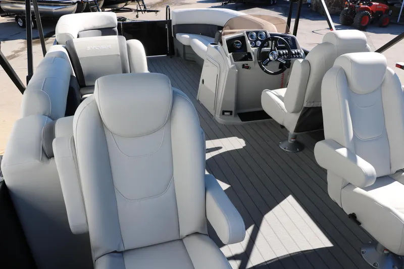 Slide: The Image of 2024 Sylvan Mirage 8522 Party Fish pontoon boat interior with luxurious seating and modern dashboard. - 18