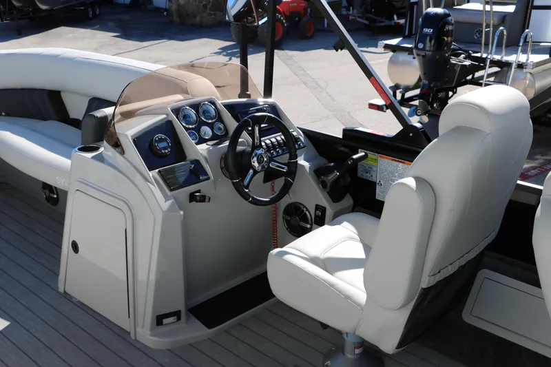 Slide: The Image of 2024 Sylvan Mirage 8522 Party Fish boat interior with captain's chair and control console. - 21