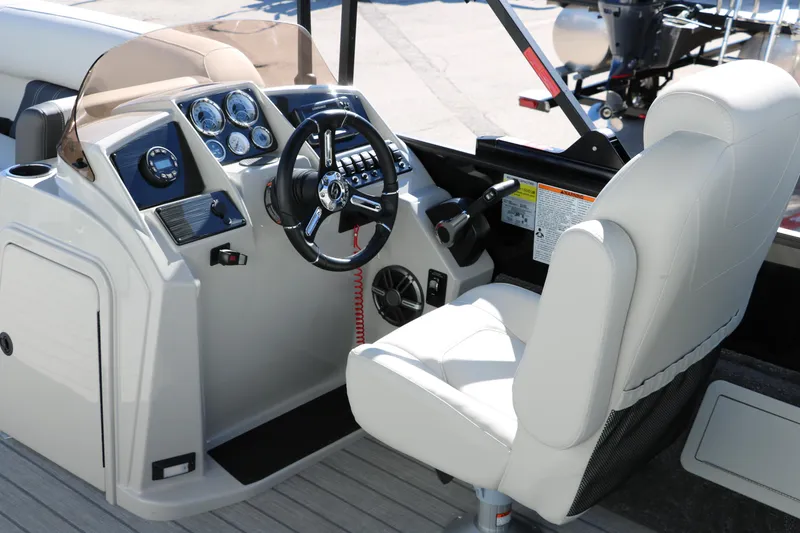 Slide: The Image of 2024 Sylvan Mirage 8522 Party Fish boat cockpit with steering wheel and control panel. - 22