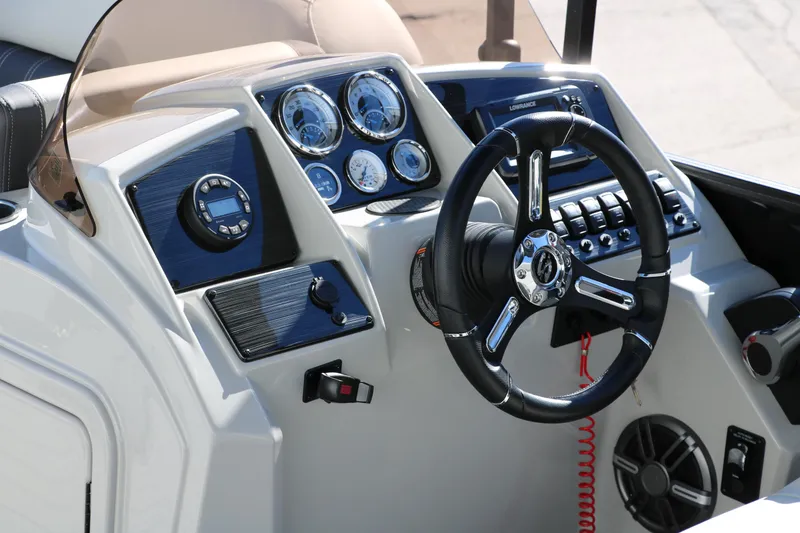 Slide: The Image of 2024 Sylvan Mirage 8522 Party Fish boat dashboard with steering wheel and control panel. - 23