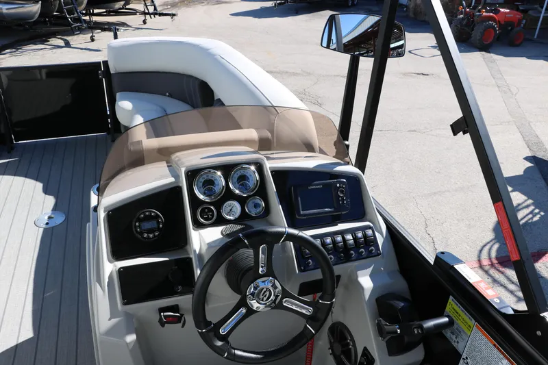Slide: The Image of 2024 Sylvan Mirage 8522 Party Fish boat dashboard and steering wheel. - 29