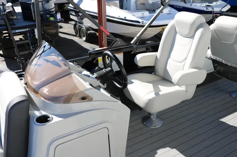 Slide: The Image of 2024 Sylvan Mirage 8522 Party Fish boat interior with captain's chair and steering console. - 37