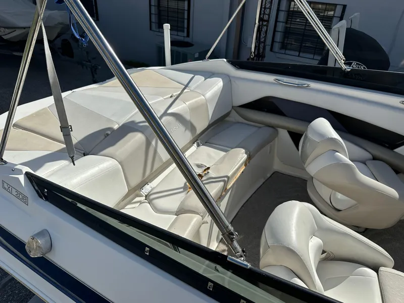 Slide: The Image of 2006 Larson LXi 208 boat interior with white leather seats and stainless steel frame. - 6