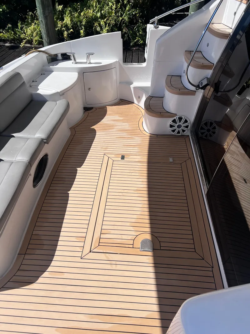 Slide: The Image of 2005 Azimut 55 Flybridge yacht deck with seating and stairs. - 12