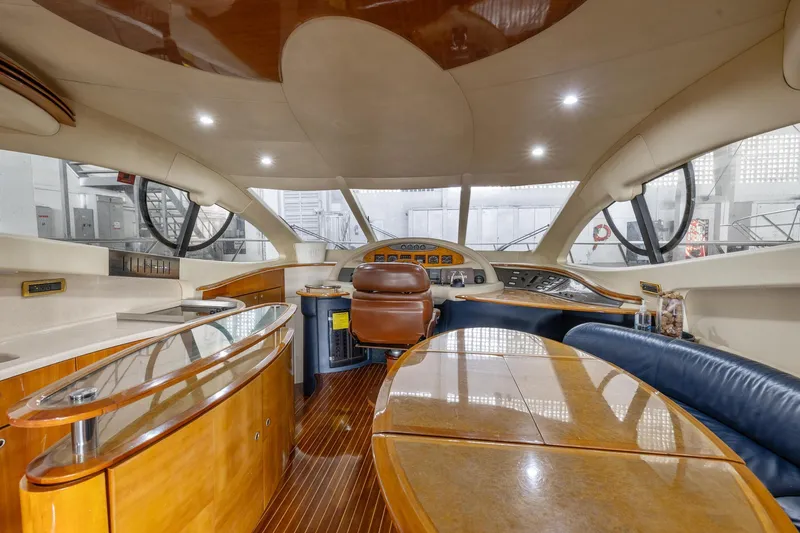 Slide: The Image of Interior of a 2005 Azimut 55 Flybridge yacht with luxurious wood finishes. - 19
