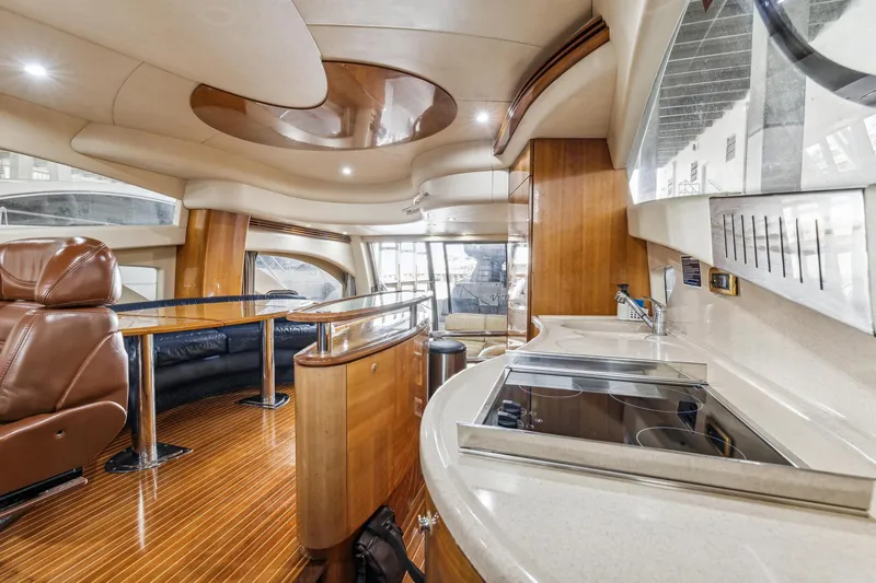 Slide: The Image of Luxurious interior of 2005 Azimut 55 Flybridge yacht with modern kitchen and seating area. - 20