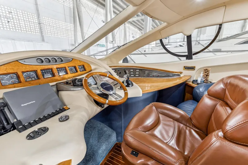 Slide: The Image of Luxurious 2005 Azimut 55 Flybridge yacht cockpit with leather seats and advanced navigation controls. - 21