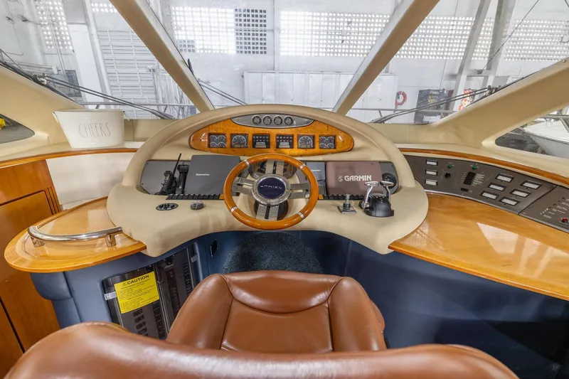 Slide: The Image of Helm station of 2005 Azimut 55 Flybridge yacht with leather seat and navigation equipment. - 22