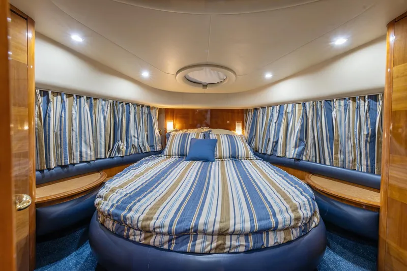 Slide: The Image of Luxurious bedroom in a 2005 Azimut 55 Flybridge yacht with striped bedding. - 29