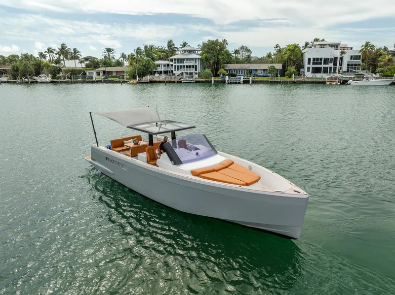Slide: The Image of 2017 Fjord 40 Open yacht on calm water near luxury waterfront homes. - 1