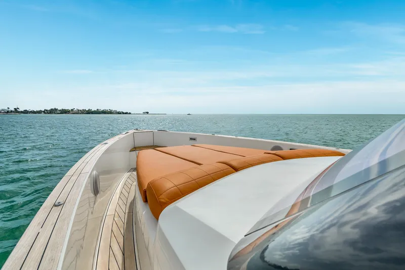 Slide: The Image of 2017 Fjord 40 Open yacht with tan seating, cruising on calm waters under a clear sky. - 10