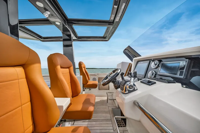 Slide: The Image of Luxurious 2017 Fjord 40 Open yacht interior with orange seats and modern dashboard. - 12