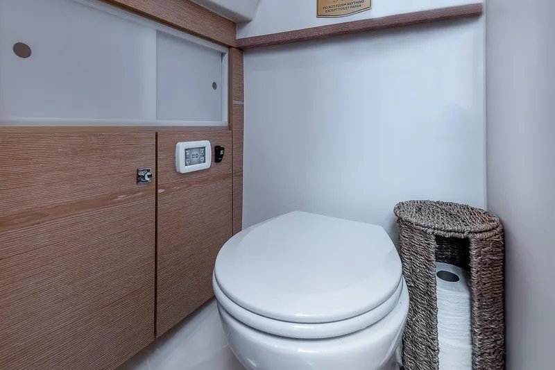 Slide: The Image of Modern bathroom in 2017 Fjord 40 Open yacht with wooden cabinetry and wicker basket. - 17