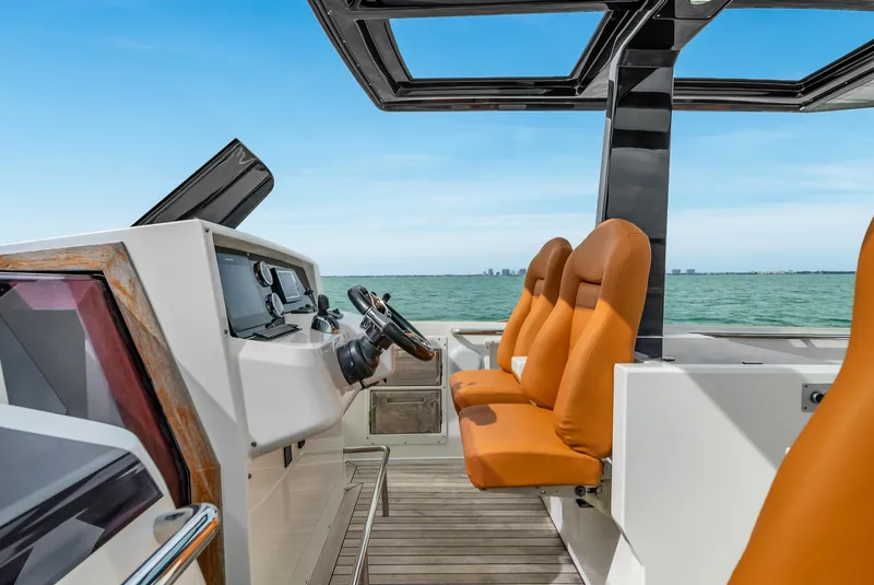 Slide: The Image of 2017 Fjord 40 Open yacht cockpit with orange seats and ocean view. - 9