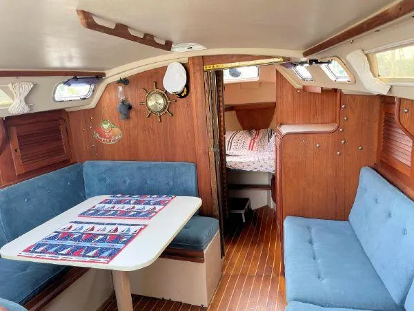 Slide: The Image of Interior of 1988 Catalina 30 MkII sailboat with blue seating and wooden accents. - 14