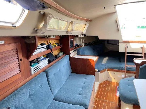 Slide: The Image of Interior of 1988 Catalina 30 MkII sailboat with blue seating and wooden accents. - 16