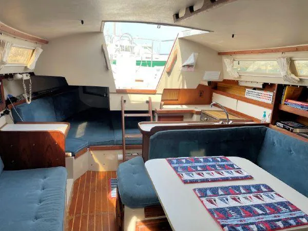 Slide: The Image of Interior of a 1988 Catalina 30 MkII sailboat with cozy seating and wooden accents. - 17