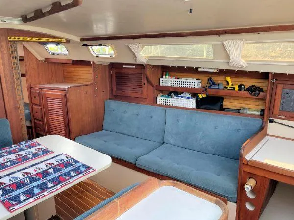 Slide: The Image of Interior of 1988 Catalina 30 MkII sailboat with blue seating and wooden cabinetry. - 18