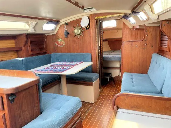 Slide: The Image of Interior of 1988 Catalina 30 MkII sailboat with blue seating and wooden finishes. - 19