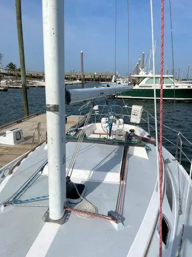 Slide: The Image of 1988 Catalina 30 MkII sailboat docked at marina, showcasing deck and rigging. - 20