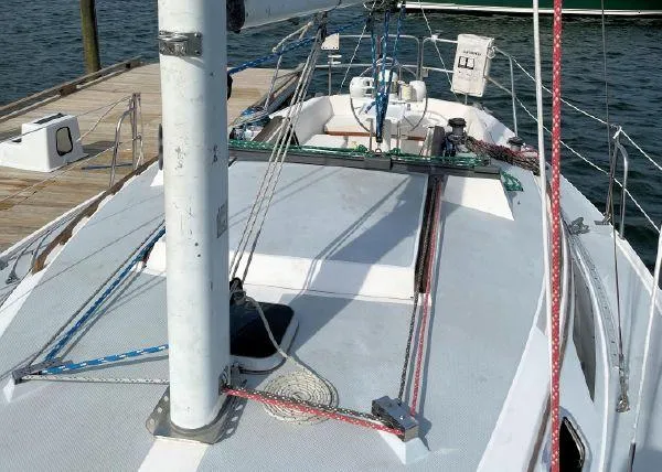 Slide: The Image of 1988 Catalina 30 MkII sailboat deck with rigging, docked at a marina. - 21
