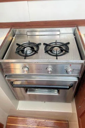 Slide: The Image of Stainless steel two-burner stove and oven in 1988 Catalina 30 MkII yacht galley. - 28