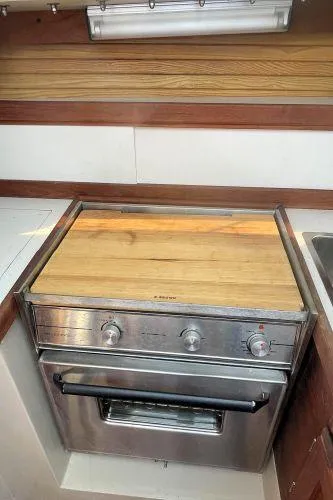 Slide: The Image of Stainless steel stove with wooden cover in 1988 Catalina 30 MkII yacht kitchen. - 29