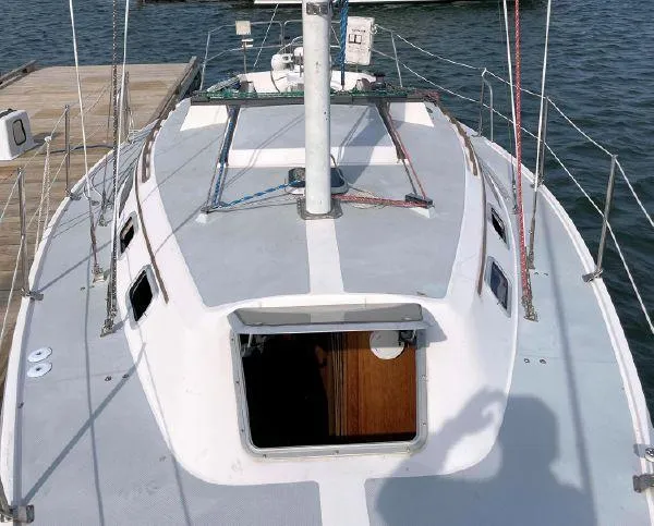 Slide: The Image of 1988 Catalina 30 MkII sailboat docked, showing deck and open cabin hatch. - 5