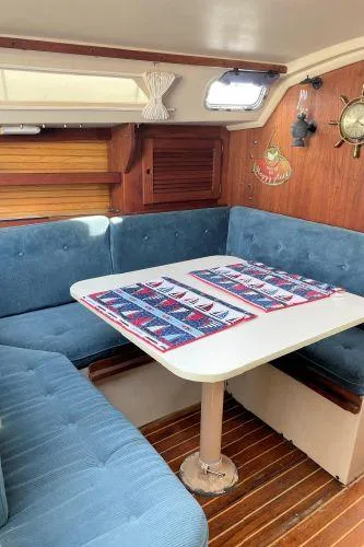 Slide: The Image of Interior of 1988 Catalina 30 MkII sailboat with blue seating and wooden accents. - 6