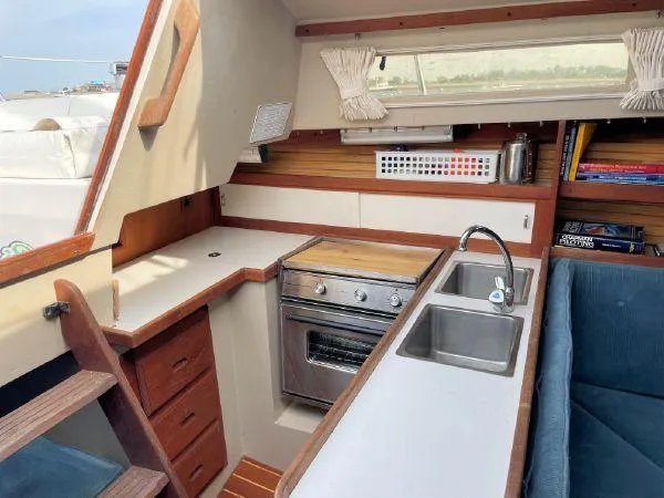 Slide: The Image of Interior of 1988 Catalina 30 MkII sailboat with compact kitchen and dual sink. - 9