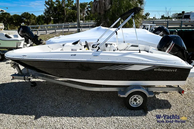 The Image of 2023 Bayliner E18 boat on a trailer in a sunny outdoor setting. - 0