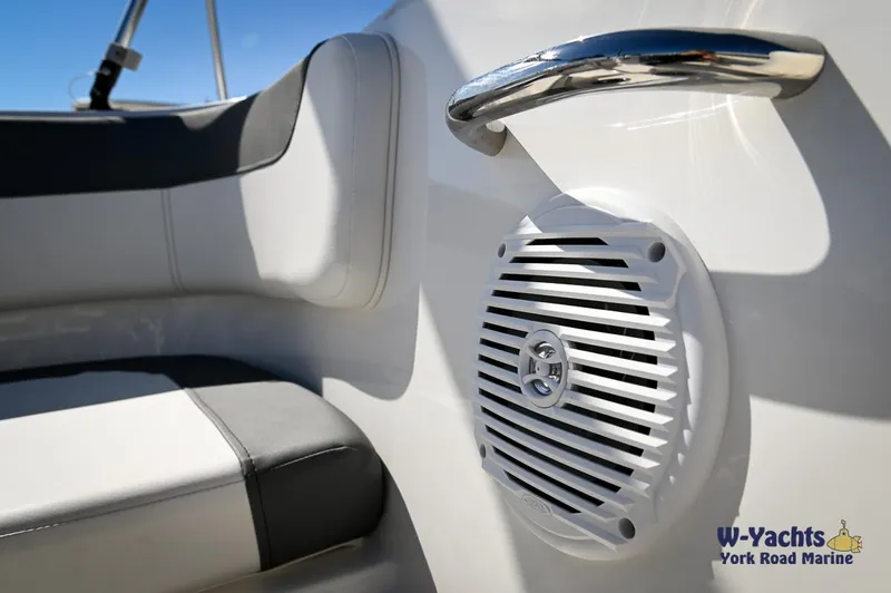 Slide: The Image of 2023 Bayliner E18 boat interior with speaker and seating. - 20