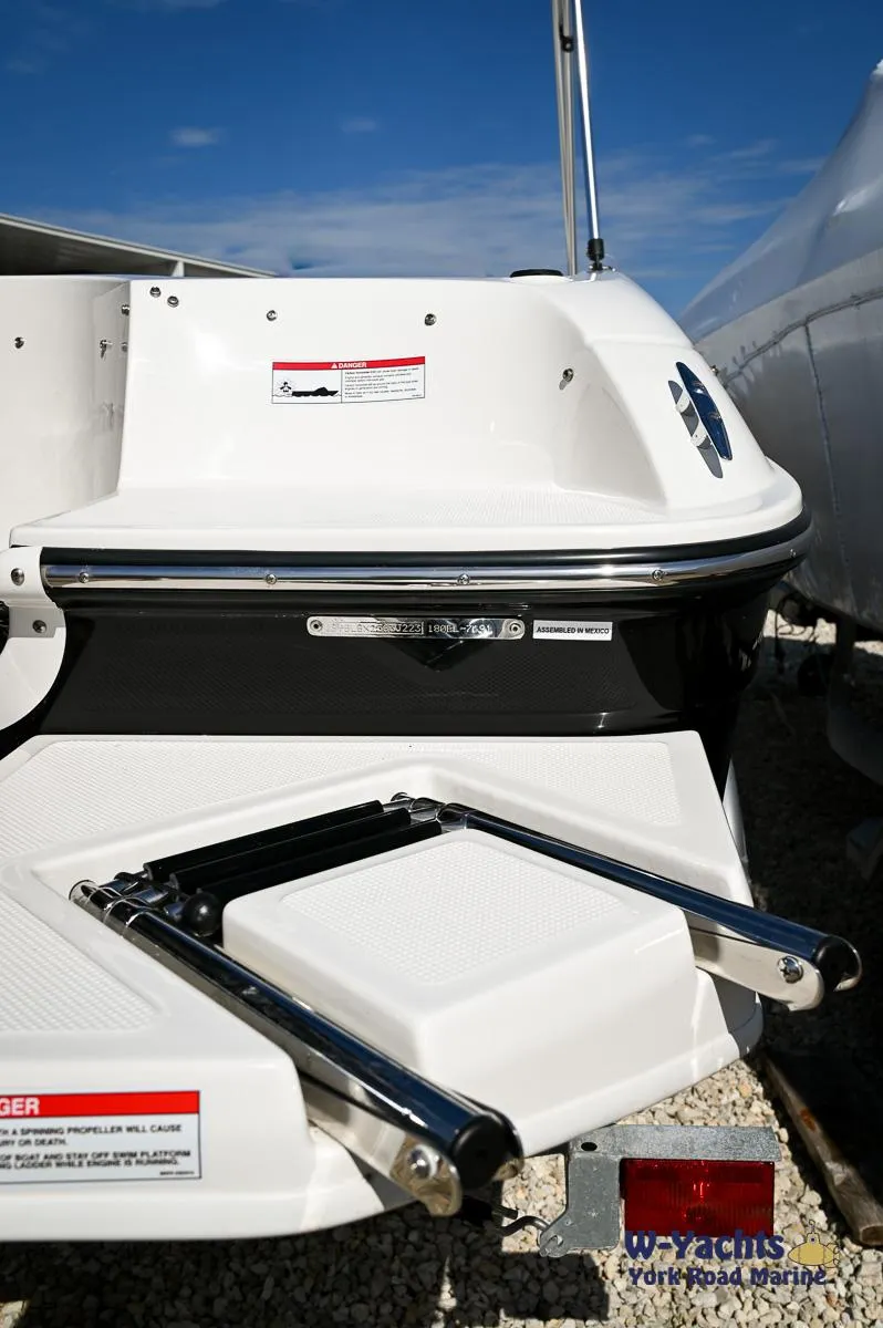 Slide: The Image of 2023 Bayliner E18 boat stern with swim ladder and York Road Marine logo. - 21