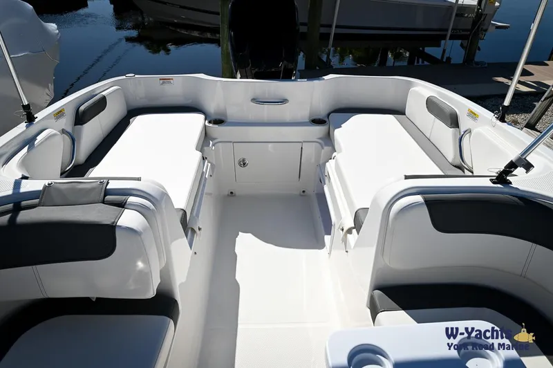 Slide: The Image of 2023 Bayliner E18 boat interior with spacious seating and storage compartments. - 4