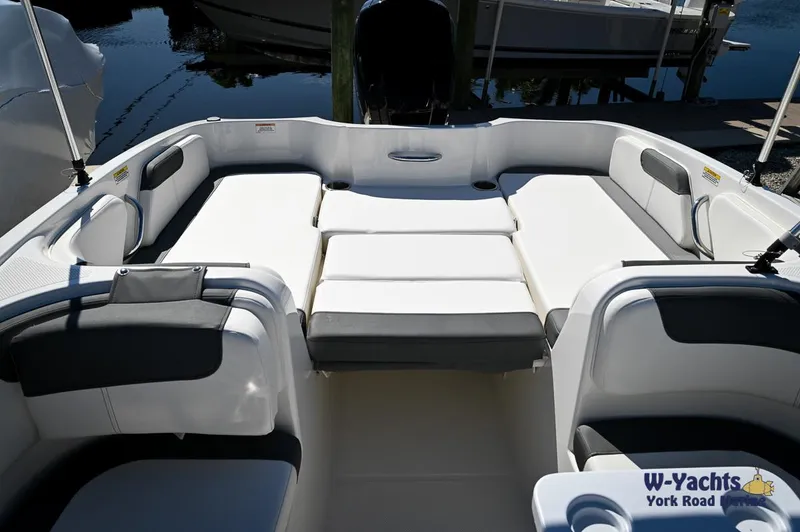 Slide: The Image of 2023 Bayliner E18 boat interior with spacious seating and sun pad. - 6
