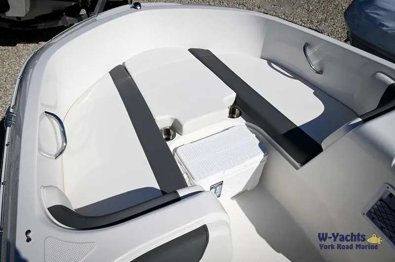 Slide: The Image of 2023 Bayliner E18 boat interior with seating and storage. - 7