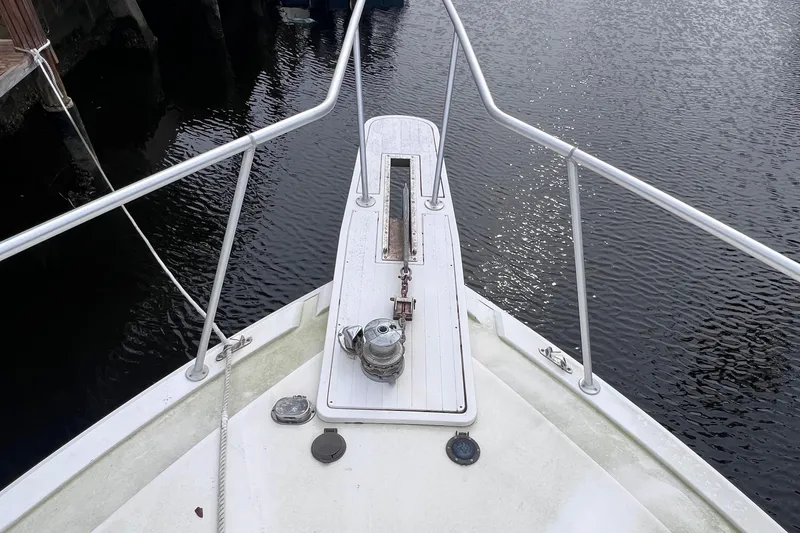 Slide: The Image of Bow of a 1988 Bertram 43 Convertible yacht with anchor and railing. - 14