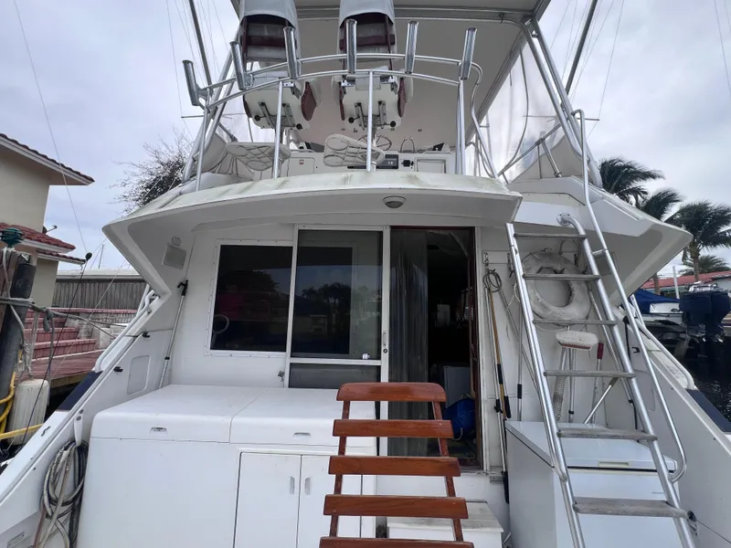 Slide: The Image of 1988 Bertram 43 Convertible yacht stern view with ladder and upper deck. - 17