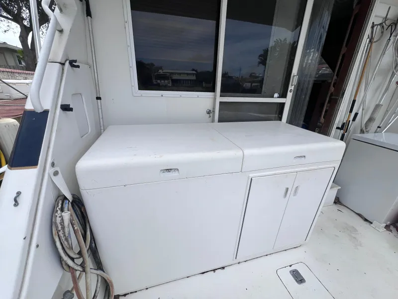 Slide: The Image of 1988 Bertram 43 Convertible boat deck with storage cabinets. - 21