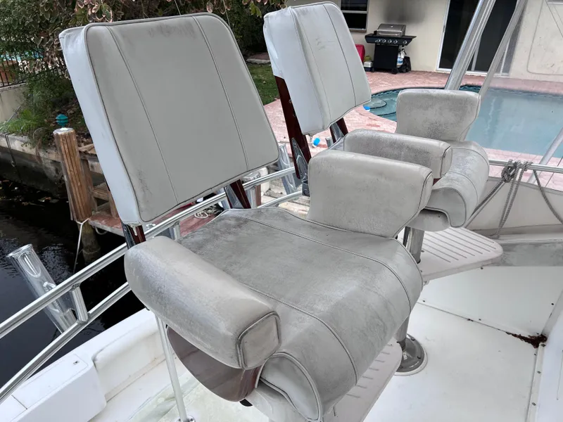 Slide: The Image of Bertram 43 Convertible 1988 boat helm seats in cockpit area. - 22