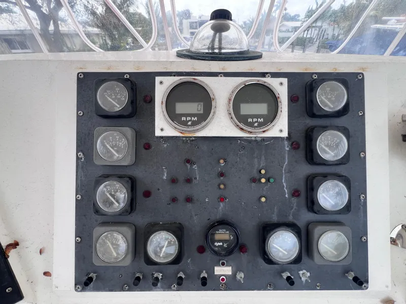 Slide: The Image of Control panel of a 1988 Bertram 43 Convertible boat with RPM gauges. - 25