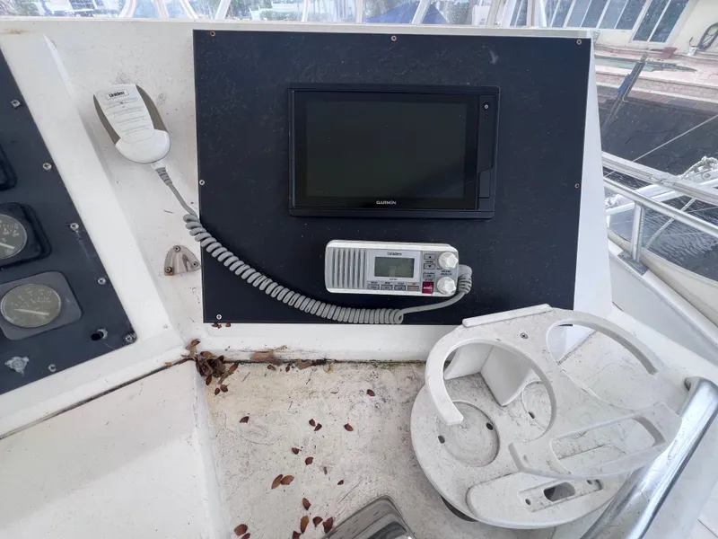 Slide: The Image of Control panel of a 1988 Bertram 43 Convertible boat with radio and monitor. - 27