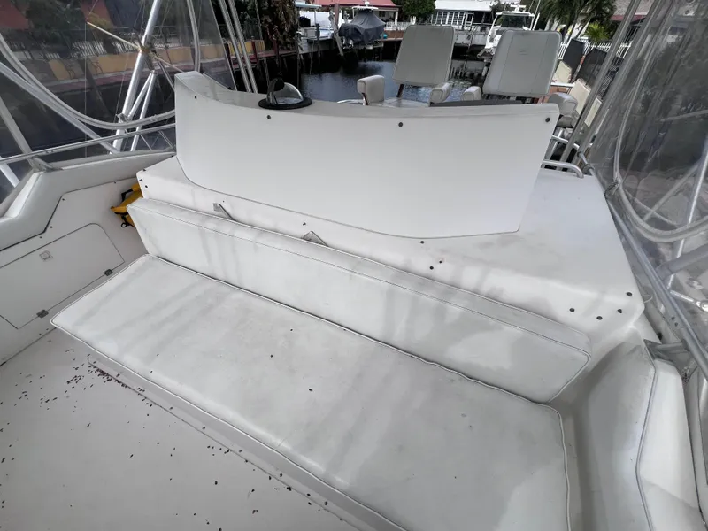 Slide: The Image of 1988 Bertram 43 Convertible boat interior with white seating and helm station. - 32
