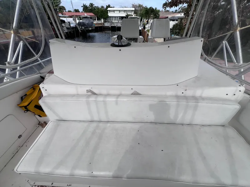 Slide: The Image of Interior of a 1988 Bertram 43 Convertible boat with white seating. - 33