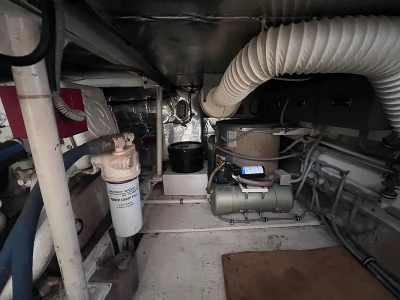 Slide: The Image of Engine room of a 1988 Bertram 43 Convertible yacht with various mechanical components. - 35