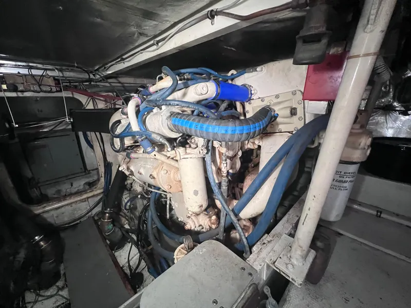 Slide: The Image of Engine compartment of a 1988 Bertram 43 Convertible boat with visible wiring and hoses. - 36