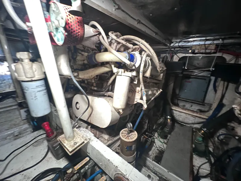 Slide: The Image of Engine room of a 1988 Bertram 43 Convertible boat showing mechanical components. - 37