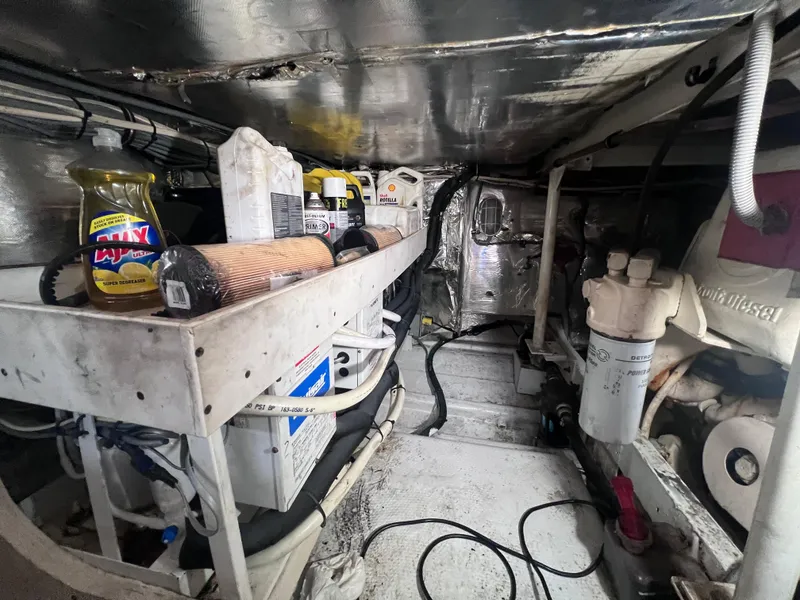Slide: The Image of Engine room of a 1988 Bertram 43 Convertible boat with maintenance supplies. - 39