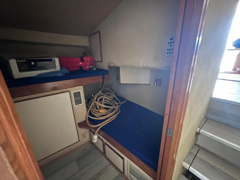 Slide: The Image of 1988 Bertram 43 Convertible interior cabin with storage and equipment. - 44